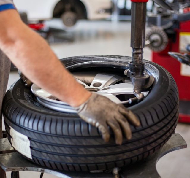 a tyre being bolted by a mechanic